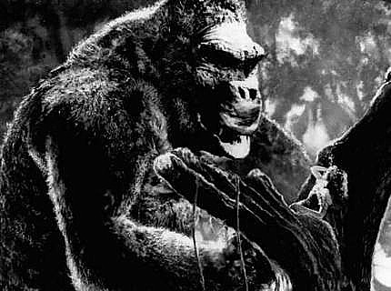 Fay Wray in the grip of the giant ape Kong, just before he does battle with a prehistoric monster who wants her, too.