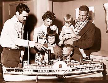 A museum staffer explains one of the museum's scale models to vistors.