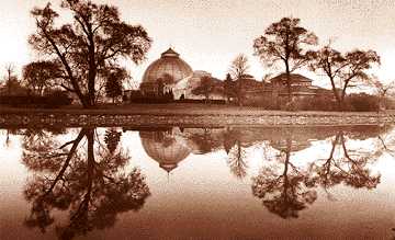 The Belle Isle Conservatory, reflected in glass-like waters.