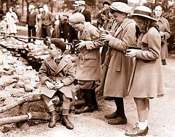 From the beginning, the zoo was a favorite place for children to visit. Here, a group of young Detroiters snap photos with box cameras on opening day, 1938. 