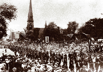 Civil War veterans attending a 1914 GAR encampment in Detroit march down Woodward past Central M.E. Church and Grand Circus Park.