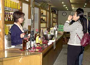 A Nanto World customer tries a shot of Okinawa's famous habu snake.
