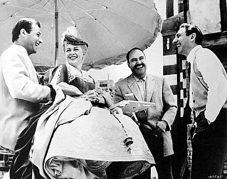 Director DAVID MILLER, right, enjoys a laugh on the set of &quot;Diane,&quot;his 1956 historical drama, with, from left, actors LEX BARKER,LANA TURNER and PEDRO ARRMENDARIZ