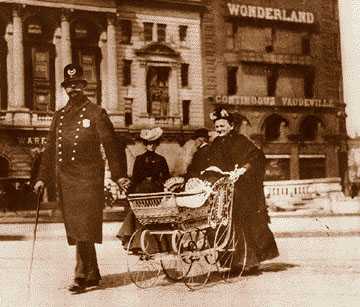 Police in the 19th century were confined to foot patrol, but had a close relationship with the community, as shown by this officer from the Detroit police Broadway Squad helping a woman and her baby cross Woodward in 1898.
